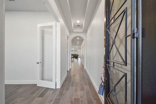 hall with hardwood / wood-style flooring