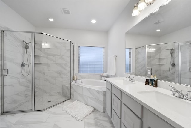 bathroom featuring vanity and independent shower and bath