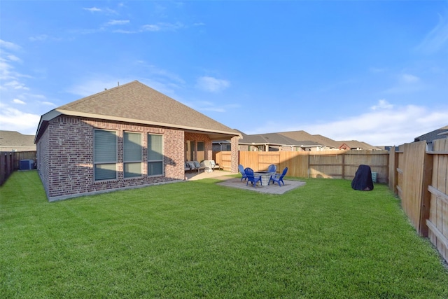 back of property with central air condition unit, a patio, and a lawn