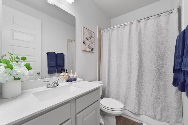 bathroom featuring hardwood / wood-style flooring, vanity, and toilet