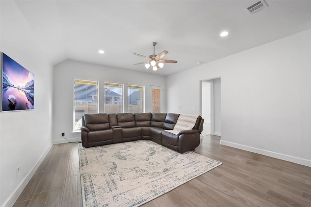 living room featuring hardwood / wood-style floors and ceiling fan