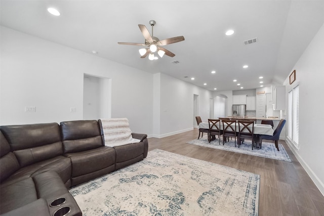 living room with ceiling fan and light wood-type flooring