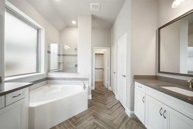 full bathroom featuring a garden tub, vanity, visible vents, a spacious closet, and a stall shower