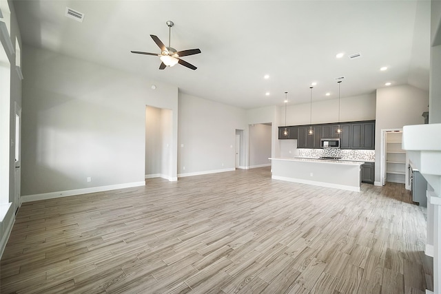 unfurnished living room with a ceiling fan, light wood-type flooring, visible vents, and recessed lighting