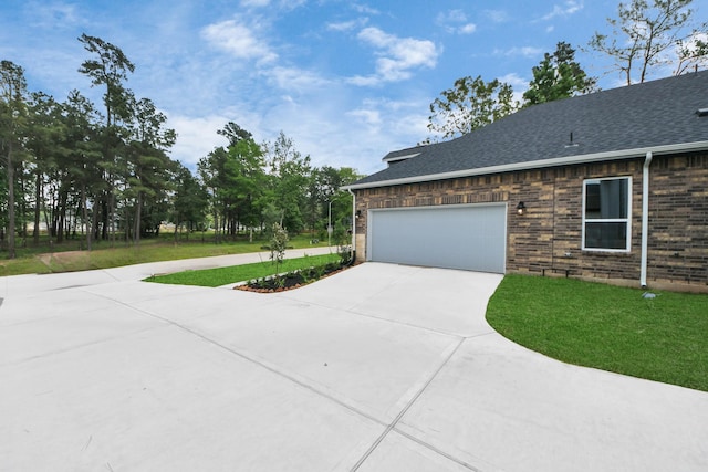 17733 Gold Saddle Ln, Magnolia, TX 77354 - view of side of home featuring a lawn, an attached garage, brick siding, and driveway