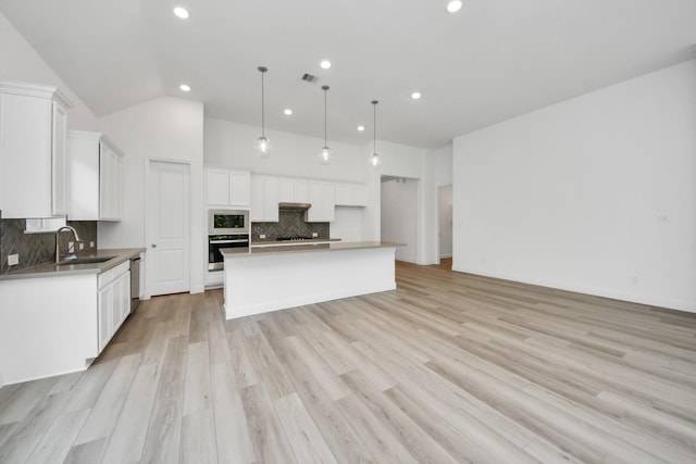 17733 Gold Saddle Ln, Magnolia, TX 77354 - kitchen featuring recessed lighting, a sink, backsplash, stainless steel appliances, and white cabinets