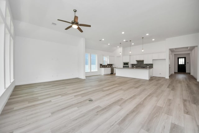 17733 Gold Saddle Ln, Magnolia, TX 77354 - unfurnished living room with light wood-type flooring, visible vents, baseboards, ceiling fan, and recessed lighting
