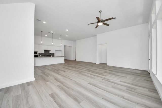 17733 Gold Saddle Ln, Magnolia, TX 77354 - unfurnished living room with recessed lighting, light wood-style floors, and ceiling fan