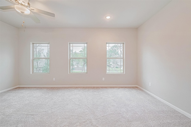 spare room featuring ceiling fan and light colored carpet