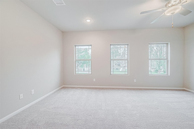 carpeted spare room with ceiling fan and a healthy amount of sunlight