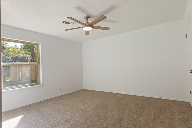 spare room with ceiling fan and carpet floors