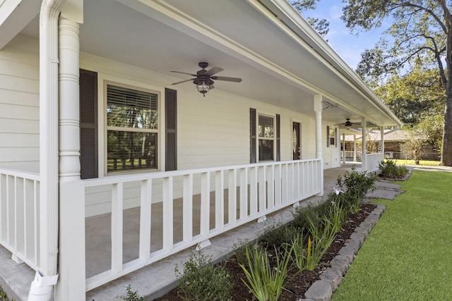 view of side of property featuring covered porch, a yard, and ceiling fan