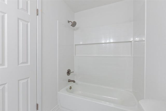 bathroom featuring shower / bathing tub combination and a textured ceiling