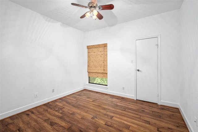 spare room with ceiling fan and dark hardwood / wood-style flooring