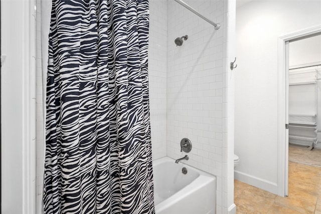 bathroom with toilet and tiled shower / bath