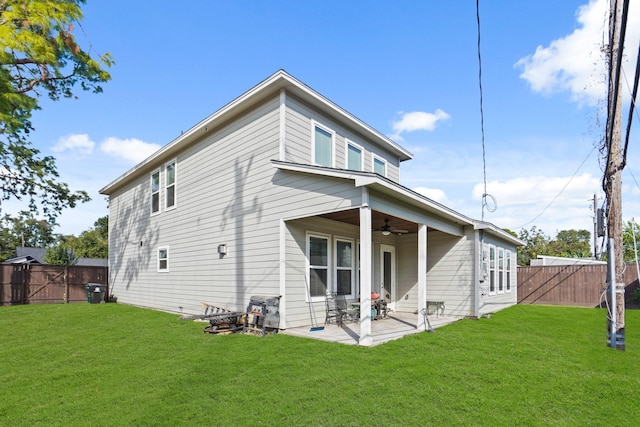 back of house with a lawn, a patio area, and ceiling fan