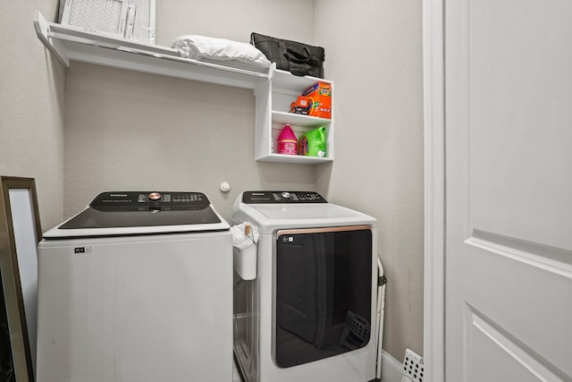 washroom featuring washer and clothes dryer