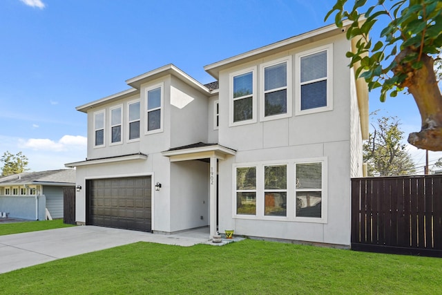 view of front of home with a front lawn and a garage