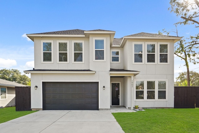 view of front facade with a front yard and a garage