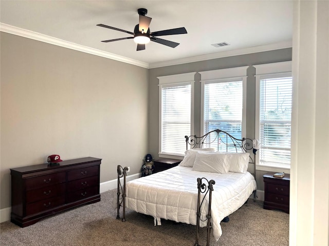 carpeted bedroom featuring ceiling fan and ornamental molding