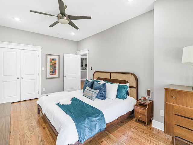 bedroom with a closet, ceiling fan, and light hardwood / wood-style floors