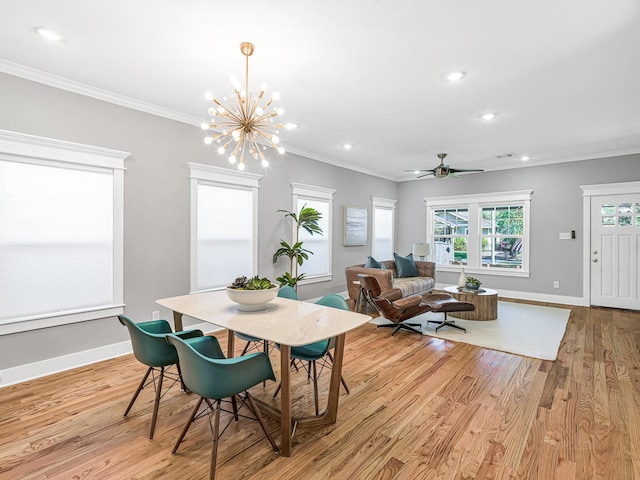 dining room with ceiling fan with notable chandelier, crown molding, and light hardwood / wood-style floors