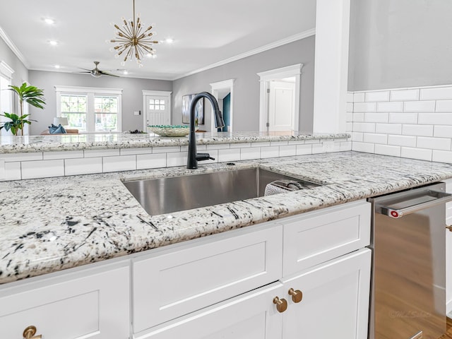 kitchen with white cabinetry, sink, ornamental molding, stainless steel dishwasher, and light stone countertops