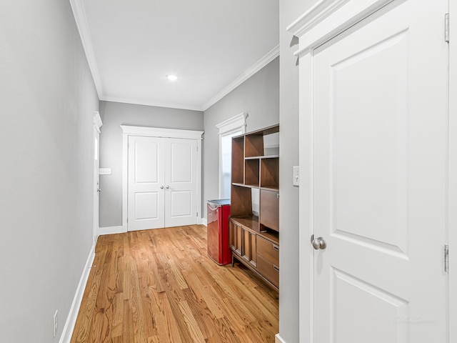 hall with crown molding and light wood-type flooring