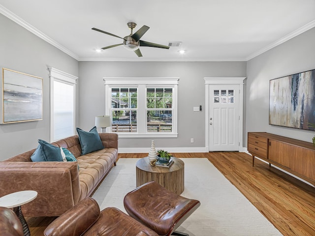 living room with crown molding, ceiling fan, and light hardwood / wood-style floors