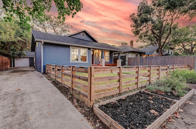 view of front of home with a garage and an outdoor structure