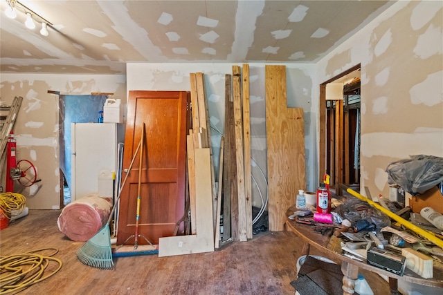 miscellaneous room featuring rail lighting and hardwood / wood-style flooring