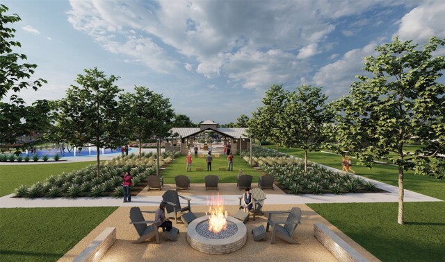 view of property's community with a fire pit, a gazebo, and a lawn