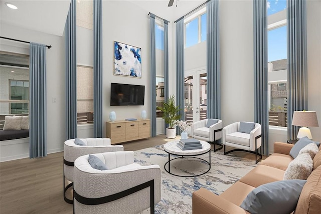 living room featuring a wealth of natural light, french doors, and wood-type flooring