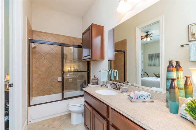 full bathroom with tile patterned flooring, ceiling fan, enclosed tub / shower combo, toilet, and vanity