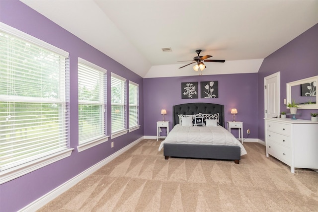 carpeted bedroom with ceiling fan and lofted ceiling