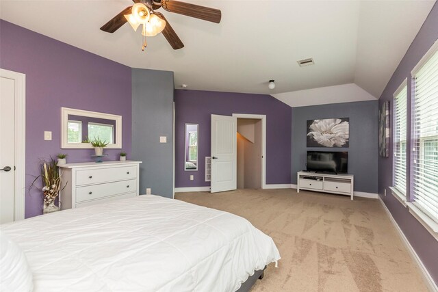 bedroom with ceiling fan, light carpet, and lofted ceiling