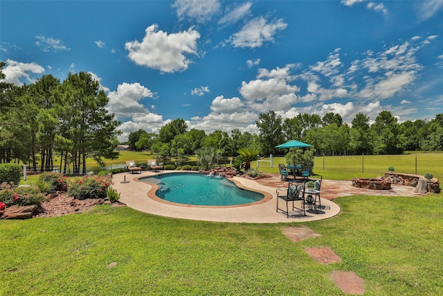 view of pool with a patio area and a yard