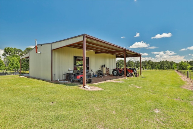 rear view of property with a yard and an outbuilding