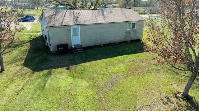 view of outbuilding featuring a yard