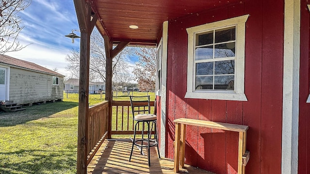 wooden terrace with a lawn