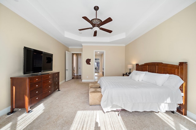 bedroom with light carpet, a raised ceiling, ceiling fan, and crown molding