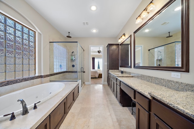 bathroom with tile patterned flooring, vanity, and plus walk in shower