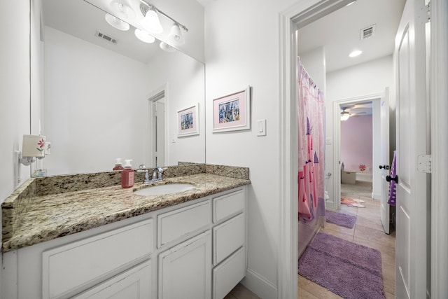 bathroom featuring tile patterned floors, vanity, and ceiling fan