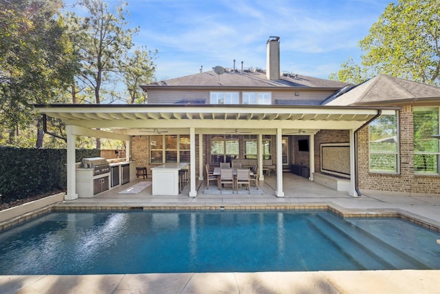 view of swimming pool featuring area for grilling, ceiling fan, and a patio