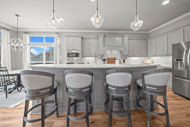 kitchen with decorative backsplash, a center island, stainless steel appliances, and gray cabinets