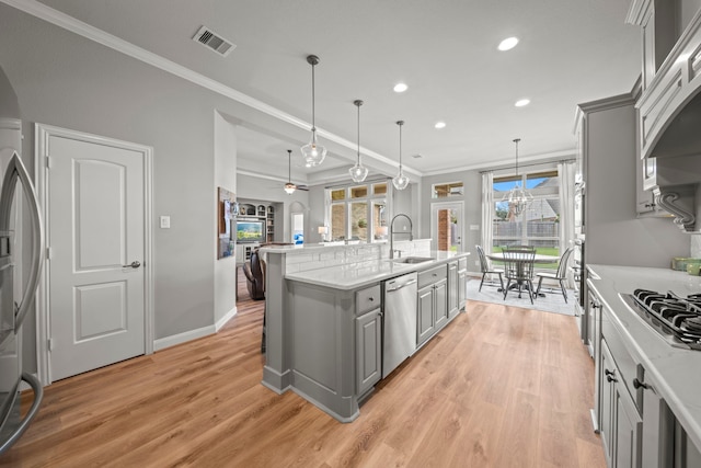 kitchen featuring gray cabinets, sink, stainless steel appliances, and ceiling fan with notable chandelier