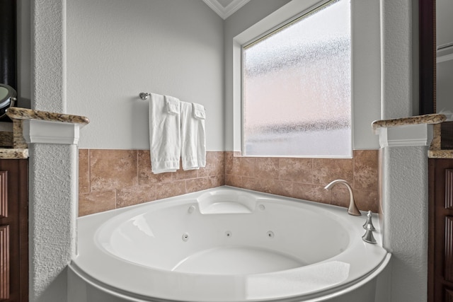 bathroom featuring vanity, a tub to relax in, and crown molding