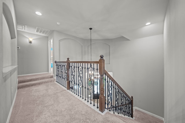 hallway with light colored carpet