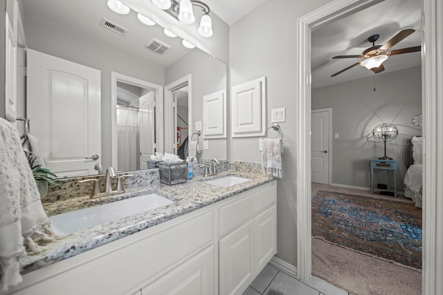 bathroom featuring tile patterned floors, vanity, and ceiling fan