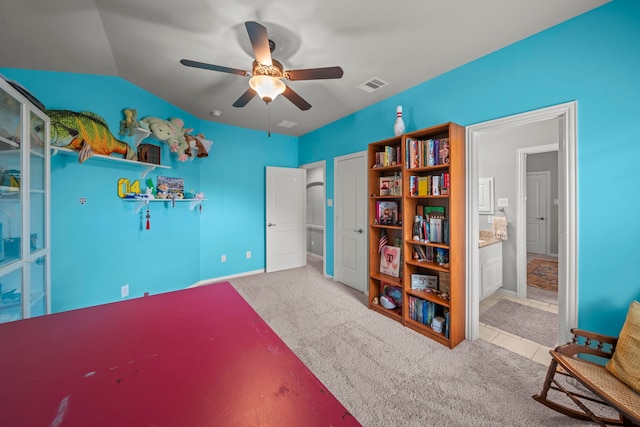 carpeted bedroom with connected bathroom, ceiling fan, and lofted ceiling